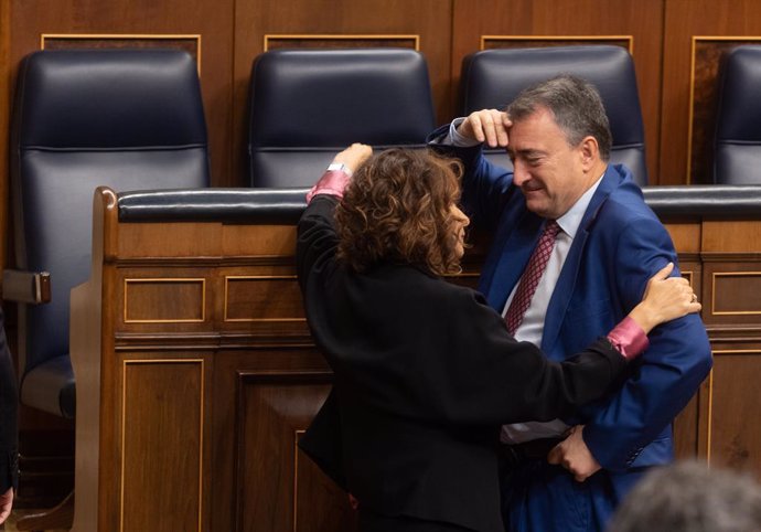 La vicepresidenta segunda y ministra de Hacienda, María Jesús Montero y el portavoz del PNV, Aitor Esteban, conversan durante una sesión plenaria, en el Congreso de los Diputados, a 30 de octubre de 2024, en Madrid (España).