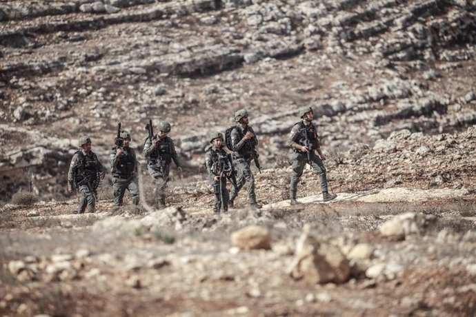 November 16, 2024, Nablus, West Bank, Palestine: Israeli soldiers guard Jewish settlers as they burn the property of Palestinian families in the town of Beit Furik, east of Nablus in the occupied West Bank. The settlers burned a car, a house and an electr