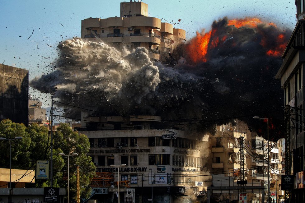 22 November 2024, Lebanon, Beirut: Smoke and fire burst from a building the minute an Israeli missile hit the Chiyah area, on the outskirts of Beirut southern suburb.