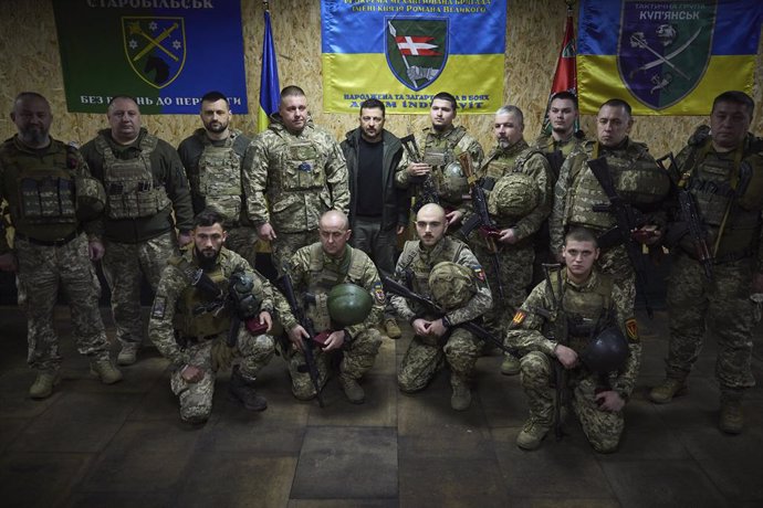 November 18, 2024, Kupyansk, Donetsk Oblast, Ukraine: Ukrainian President Volodymyr Zelenskyy, center, stands for a group photo with members of the Prince Roman the Great 14th separate mechanized brigade on the frontlines, November 18, 2024, in Kupyansk, 