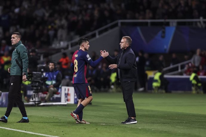 Pedro Gonzalez Pedri and Hansi Flick, head coach of FC Barcelona greets during the UEFA Champions League 2024/25 League Phase MD5, match between FC Barcelona and Stade Brestois 29 at Estadi Olimpic Lluis Companys on November 26, 2024 in Barcelona, Spain.