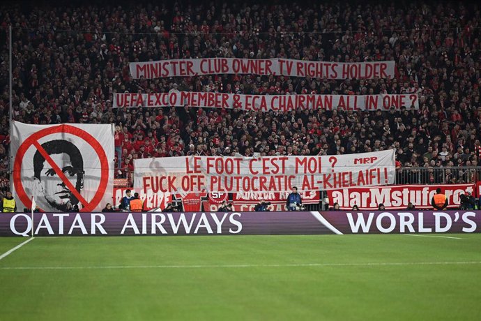 26 November 2024, Bavaria, Munich: Munich Fans hold up banners against President of Paris Saint-Germain Nasser Al-Khelaifi during the UEFA Champions League soccer match between FC Bayern Munich and Paris Saint-Germain at the Allianz Arena. Photo: Tom Well