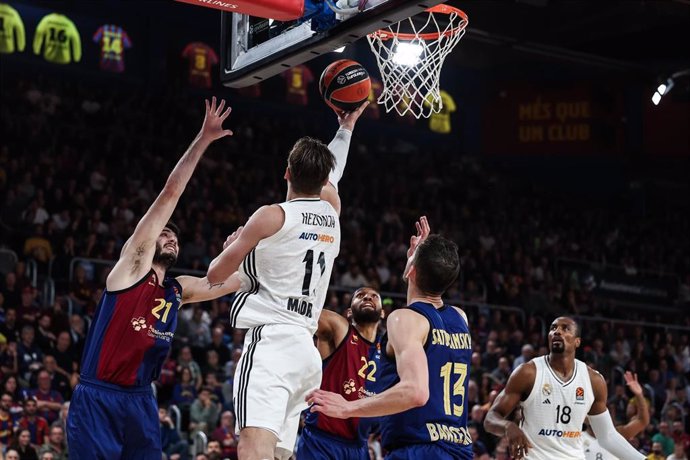 Mario Hezonja of Real Madrid and Alex Abrines of FC Barcelona compete for the ball during the Turkish Airlines Euroleague, match played between FC Barcelona and Real Madrid at Palau Blaugrana on November 28, 2024 in Barcelona, Spain.