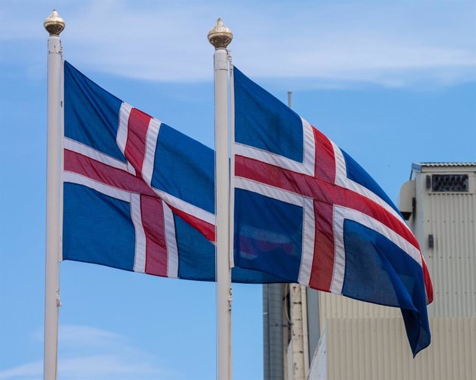 Archivo - July 30, 2015 - Iceland - A pair of flags of the republic of Iceland, sky blue with a snow-white cross, and a red cross inside the white cross.