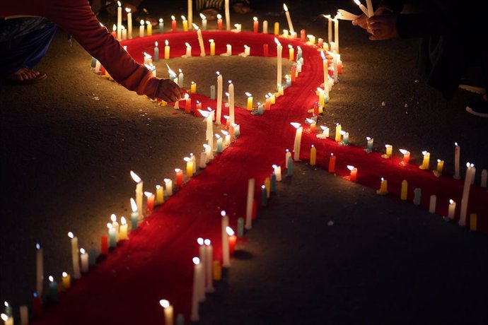 November 30, 2024, Kathmandu, Kathmandu, Nepal: Nepali activists' light candles along the edge of red ribbon during an awareness event organized on the eve of "World AIDS day" in Kathmandu on November, 30, 2024.