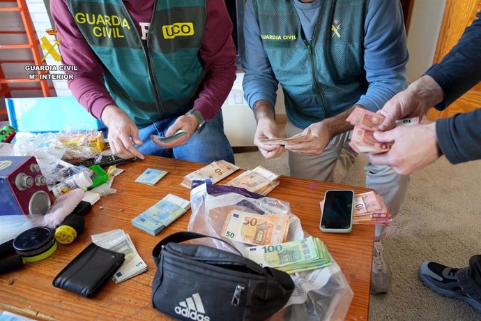 Agentes de la Guardia Civil, con dinero recuperado en la operación