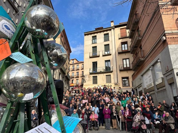 Imagen de todos los asistentes, con el 'arbol de deseos' en primer plano.