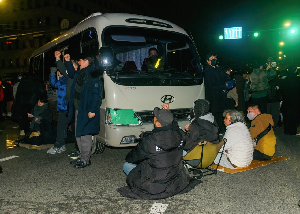 December 4, 2024, Seoul, South Korea: People block martial law military vehicles in front of the National Assembly in Seoul. South Korea's President Yoon Suk Yeol on December 3 declared martial law.