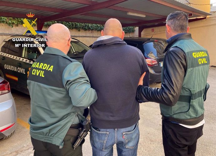 El detenido, en el centro, custodiado por dos agentes de la Guardia Civil