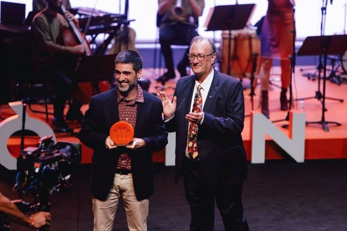 El 65 Premi Sant Jordi de Novel·la, Roc Casagran, junto al presidente de Òmnium Cultural, Xavier Antich, tras recibir el galardón este jueves en la 74 Nit de Santa Llúcia en el TNC