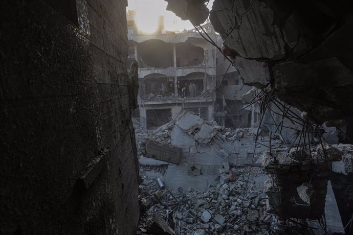 December 13, 2024, Nuseirat, Gaza Strip, Palestinian Territory: Palestinian residents of the area inspect the targeted building and surrounding structures that sustained damage after Israeli attack on Nuseirat Refugee Camp in Gaza City, Gaza on December 1