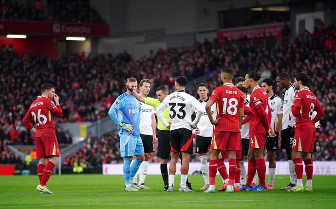 14 December 2024, United Kingdom, Liverpool: Referee Tony Harrington gives a red card to Liverpool's Andrew Robertson (L) during the English Premier League soccer match between Liverpool and Fulham at Anfield. Photo: Peter Byrne/PA Wire/dpa