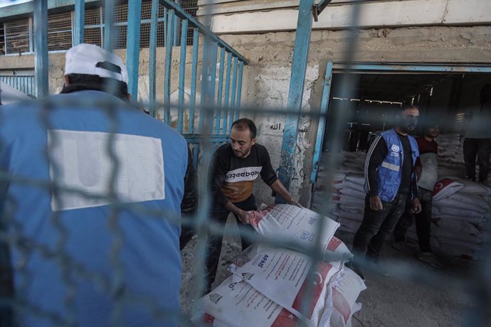 December 3, 2024, Nuseirat, Gaza Strip, Palestinian Territory: Palestinians receive bags of flour distributed by the United Nations Relief and Works Agency for Palestine Refugees (UNRWA), amid the conflict between Israel and Hamas, in the Nuseirat refugee