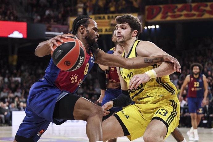 Kevin Punter of FC Barcelona and Tarik Biberovic of Fenerbahce in action during the Turkish Airlines Euroleague, match played between FC Barcelona and Fenerbahce Beko Istanbul at Palau Blaugrana on December 17, 2024 in Barcelona, Spain.