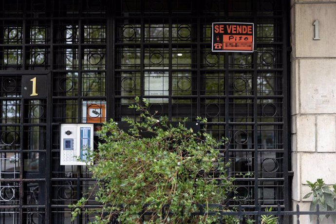 Archivo - Vista de un cartel de 'Se vende' en un portal de un edificio.