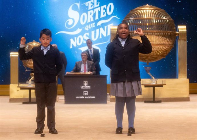 Axiel Kyron Abas y Ainhoa Rosero Gómez Limbaga cantan el tercer premio, el número 11.840 durante la celebración del Sorteo Extraordinario de la Lotería de Navidad 2024, en el Teatro Real, a 22 de diciembre de 2024, en Madrid (España). 