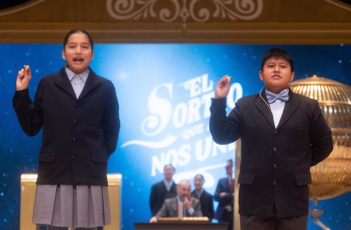 Piero Rai Chávez Huaroto y Alisce Ríos Gonzales cantan el primer premio, el 'Gordo', el número 72.480 durante la celebración del Sorteo Extraordinario de la Lotería de Navidad 2024, en el Teatro Real, a 22 de diciembre de 2024, en Madrid (España). El Esta