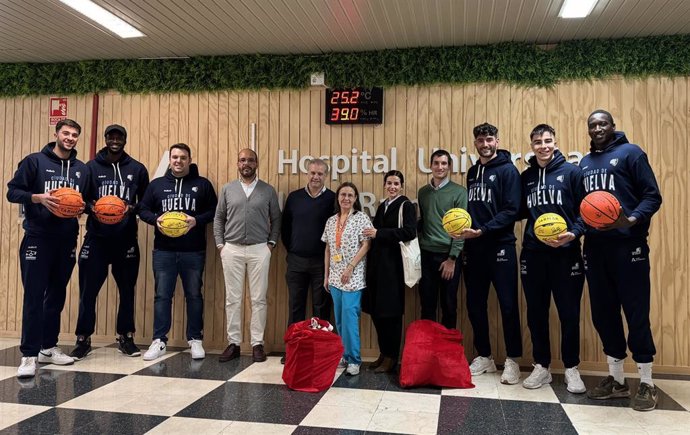 Jugadores del equipo de baloncesto y miembros de la compañía Emerita Resources en su visita a los niñoa del Hospital Juan Ramón Jiménez de Huelva.