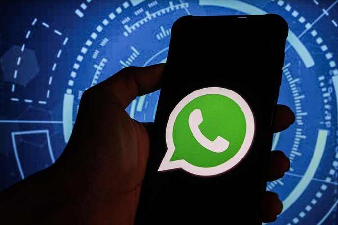 December 19, 2024, Bandung, West Java, Indonesia: In this photo illustration, Whatsapp logo is displayed on a smartphone with Cyber Meta Logo in the background.