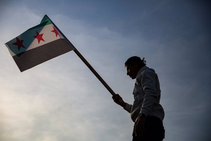 December 9, 2024: Damascus, Syria. 09 December 2024. A boy waves the Syrian opposition flag on an abandoned tank in the Umayyad Square in Damascus in the aftermath of the fall of the Al-Assad regime. A number of people gathered in the square raising oppos