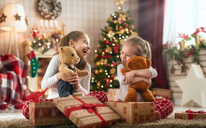 Archivo - Niñas abriendo sus regalos de Navidad.