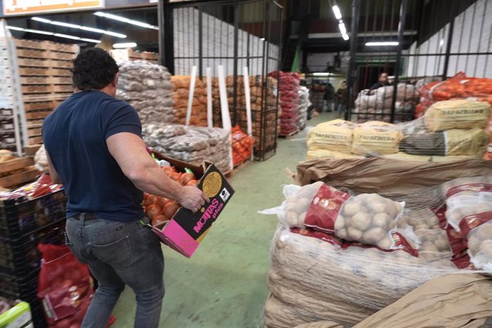 Archivo - Un trabajador sujeta una caja con cebollas en Mercabilbao,