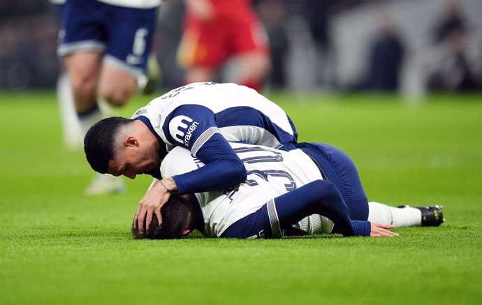 08 January 2025, United Kingdom, London: Tottenham Hotspur's Pedro Porro checks on team-mate Rodrigo Bentancur as he lies on the ground during the English Carabao Cup semi-final first leg soccer match between Tottenham Hotspur and Liverpool at the Tottenh