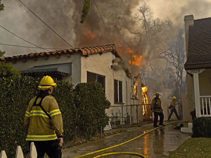 January 10, 2025, Altadina, California, USA: Fireman tend to homes on fire as businesses and properties were destroyed in the aftermath of the fierce Eaton fires on Wednesday, January 8, 2025, in Altadena, California. NICK UT/PI