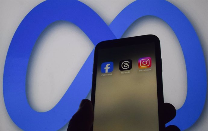 January 7, 2025, London, England, UK: Facebook, Threads and Instagram apps on a phone screen and the Meta logo in the background as Meta founder Mark Zuckerberg announces that the social media giant will reduce censorship, begin recommending more politica