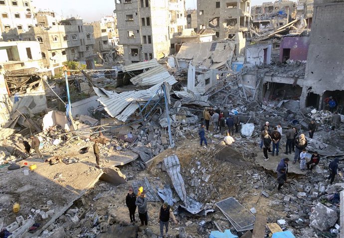 January 13, 2025, Gaza City, Gaza Strip, Palestinian Territory: People search for their belongings amid the rubble of buildings destroyed in Israeli airstrikes in Gaza City on January 13, 2025, amid the ongoing war in the Palestinian territory between Isr