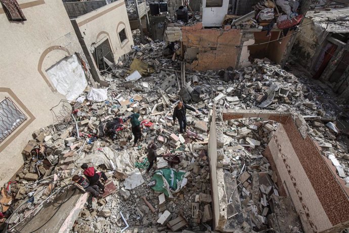 January 15, 2025, Deir Al-Balah, Gaza Strip, Palestinian Territory: Palestinian residents inspect the area amid the rubble of destroyed buildings following an Israeli airstrike on the Khatib family in the Deir al-Balah refugee camp in the central Gaza Str