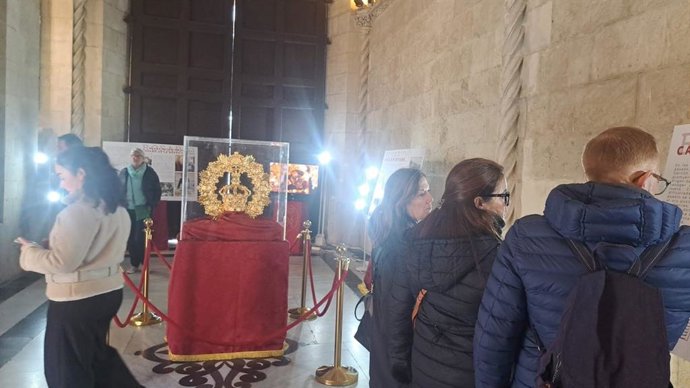 Visitantes de la exposición 'Carrión en tu corona', con la nueva presea de la Virgen del Rosario, en el Salón del Apeadero del Ayuntamiento.