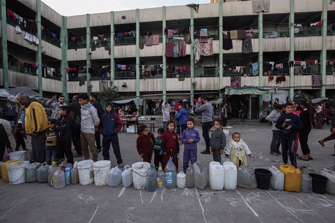 07 January 2025, Palestinian Territories, Deir al Balah: Displaced Palestinians wait to fill on water at a make-shift camp for the internally displaced in Deir al Balah in the central Gaza Strip. Photo: Omar Ashtawy/APA Images via ZUMA Press Wire/dpa