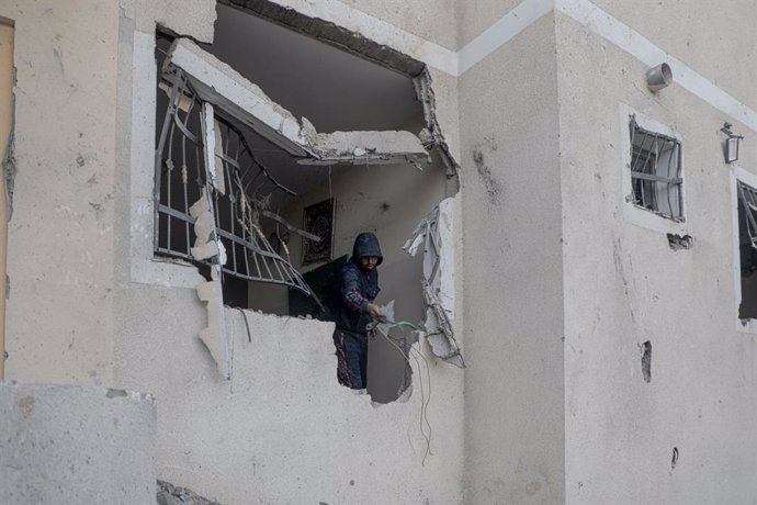 GAZA, Jan. 15, 2025  -- A Palestinian man is seen in a damaged house after an Israeli bombardment in Deir al-Balah, central Gaza Strip, on Jan. 15, 2025. Israel and Hamas have agreed to a Gaza ceasefire-for-hostages deal following intensive mediation by Q