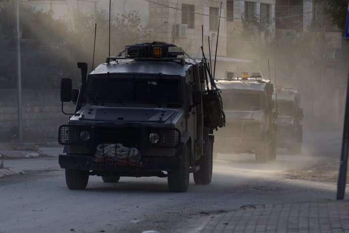 TULKARM, Dec. 25, 2024  -- Israeli military vehicles are seen during an Israeli raid in the Tulkarm refugee camp in the northern West Bank, on Dec. 25, 2024. The Israeli army has been carrying out a large-scale military operation since Tuesday in the Tulk