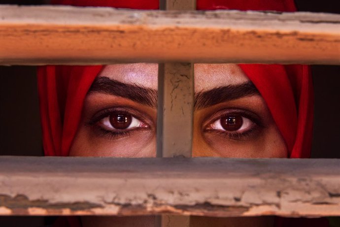 Archivo - May 1, 2023, Barcelona, Spain: LIZA ANVARY, an Afghan refugee, looks through a window frame she says represents the prison like situation of women in her country. Liza worked for the Afghan government before the Taliban took power. Two years ago