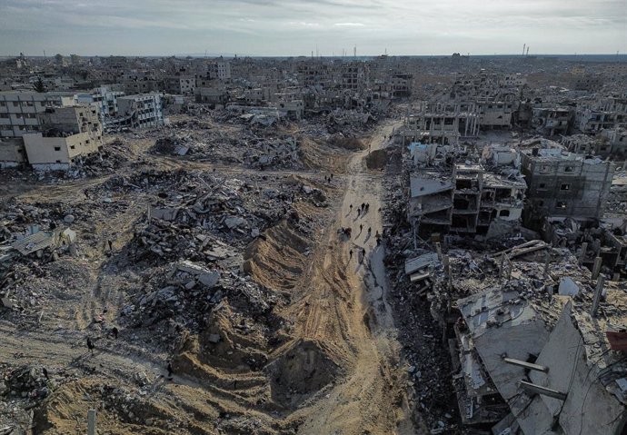 January 19, 2025, Rafah, Gaza Strip, Palestinian Territory: An aerial view taken with a drone shows internally displaced Palestinians walking along a street among the rubble of destroyed buildings amid a ceasefire between Israel and Hamas, in Rafah, south