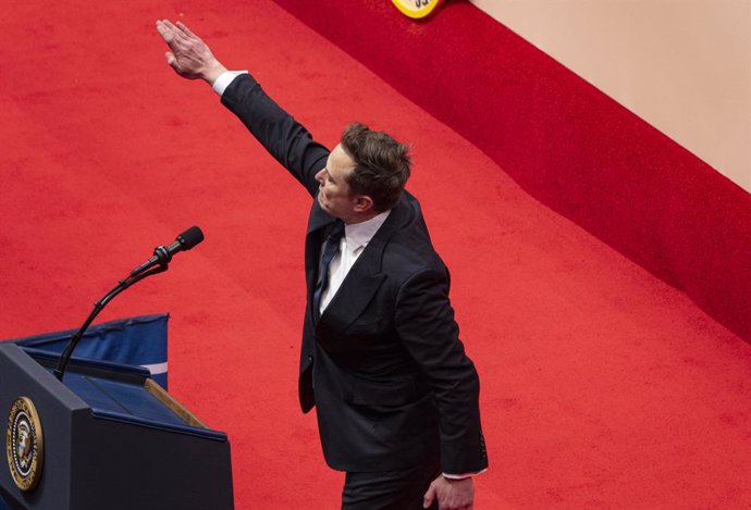 January 20, 2025, Washington Dc, Ca - California, United States: Elon Musk salutes the crowd at an indoor Presidential Inauguration parade event for President Donald Trump in Washington, Monday, Jan. 20, 2025.