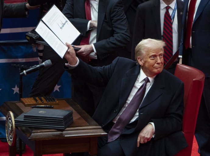 January 20, 2025, Washington, District of Columbia, USA: President Donald Trump shows off an executive order he signed at an indoor Presidential Inauguration parade event at the Capital One Arena in Washington.