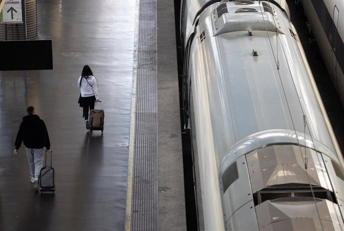 Dos personas durante la segunda operación salida por Navidad, en la estación de tren de Atocha-Almudena Grandes, a 27 de diciembre de 2024, en Madrid (España).