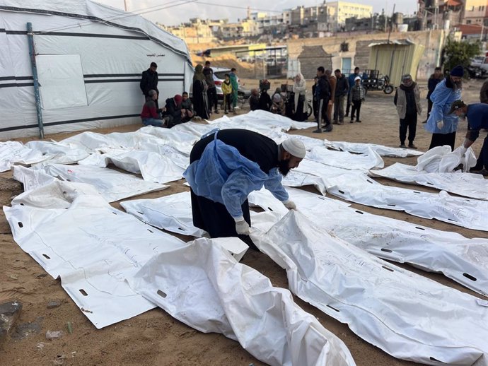 January 23, 2025, Khan Yuis, Gaza Strip, Palestinian Territory: Palestinians collect the remains of more than 50 bodies from under the rubble of homes destroyed by the Israeli army during its military operations in Khan Younis, southern Gaza Strip, on 22 