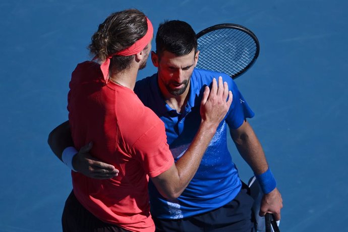 24 January 2025, Australia, Melbourne: Serbian tennis player Novak Djokovic embraces German tennis player Alexander Zverev after retiring from his semi-final match during the 2025 Australian Open at Melbourne Park. Photo: Joel Carrett/AAP/dpa