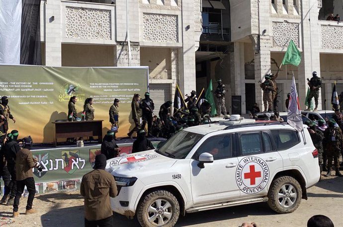 January 25, 2025, Gaza City, Gaza Strip, Palestinian Territory: Hamas fighters escort four Israeli hostages, (center: L-R) Naama Levy, Liri Albag, Daniella Gilboa and Karina Ariev, on a stage before handing them over to a team from the Red Cross in Gaza C