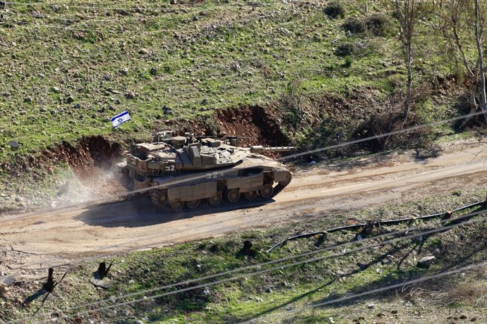 CHAQRA, Jan. 26, 2025  -- This photo taken on Jan. 25, 2025 shows an Israeli tank cutting a road to the southern Lebanon in Chaqra, Lebanon. The death toll from Israeli gunfire targeting crowds of Lebanese trying to return to their homes in southern Leban