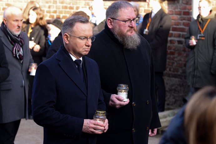 January 27, 2025, Oswiecim, Poland: Polish President Andrzej Duda and Piotr Cywinski, Auschwitz Museum director, pay homage at 'The Death Wall' during the 80th anniversary of the liberation of Auschwitz at Memorial and Museum Auschwitz-Birkenau former Naz