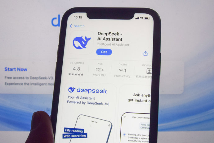 27 January 2025, United Kingdom, London: In this photo illustration, the DeepSeek app is seen on a phone screen with the DeepSeek website in the background.