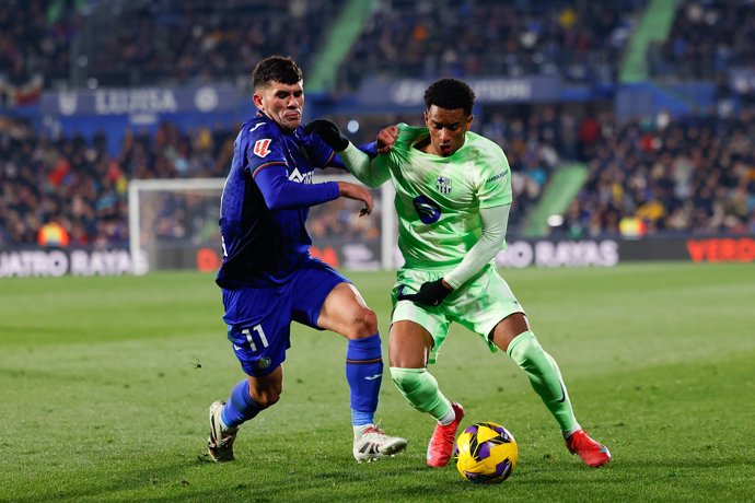 Alejandro Balde of FC Barcelona and Carles Alena of Getafe CF in action during the Spanish League, LaLiga EA Sports, football match played between Getafe CF and FC Barcelona at Coliseum de Getafe stadium on January 18, 2025, in Madrid, Spain.