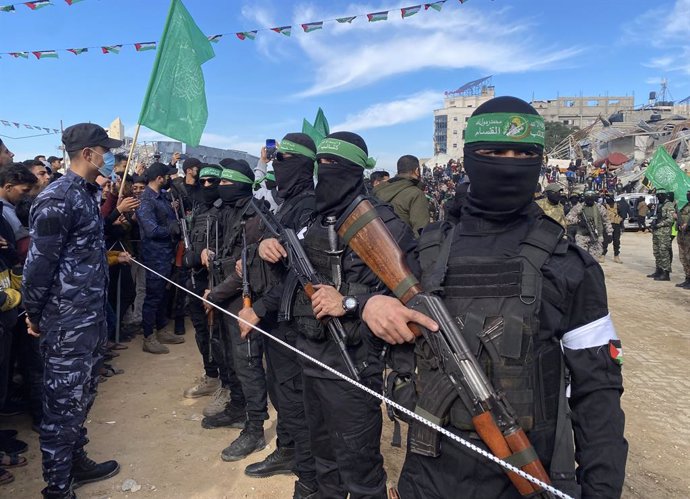 January 25, 2025, Gaza City, Gaza Strip, Palestinian Territory: Hamas fighters secure an area in a square before handing over four Israeli hostages to a Red Cross team in Gaza City on January 25, 2025. Four freed Israeli women hostages were home in Israel