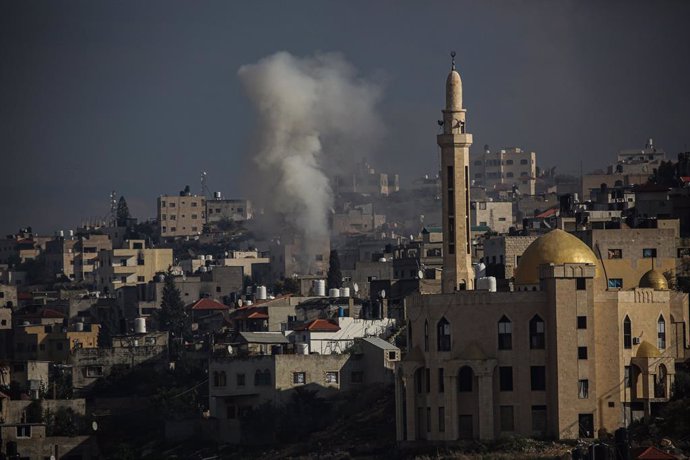 January 24, 2025, Nablus, West Bank, Palestinian Territory: Smoke from an explosion billows as homes are demolished in Jenin refugee camp in the West Bank during an Israeli military operation.