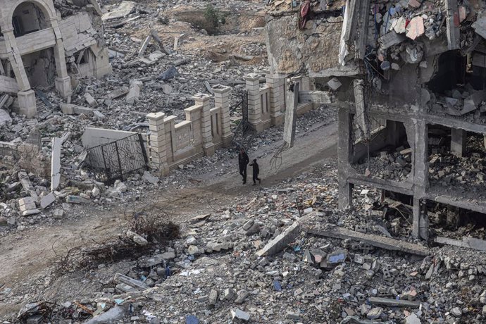 February 3, 2025, Gaza City, Gaza Strip, Palestinian Territory: Internally Palestinians walk along a street among the rubble of destroyed buildings amid a ceasefire between Israel and Hamas, in Gaza City, 03 February 2025. Israel and Hamas implemented the